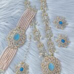 bridal jewelry set featuring a necklace, choker, earrings, and a maang tikka