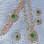 bridal jewelry set featuring a necklace, choker, earrings, and a maang tikka