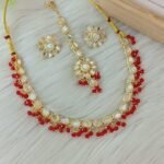 ndian-style antique Kundan jewellery set includes a necklace, earrings, and a maang tikka,