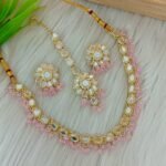 ndian-style antique Kundan jewellery set includes a necklace, earrings, and a maang tikka,