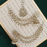 Pakistani-style mirror worked jhumka earrings and a tikli