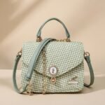 small, mint green and white houndstooth pattern crossbody handbag with gold-tone hardware and a top handle.