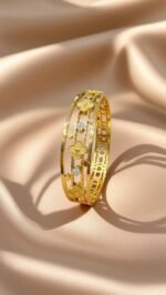 floral-designed bangle featuring clover motifs and crystal accents
