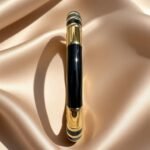 gold and black enamel bracelet,