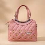 quilted PU leather top-handle handbag with embroidered details and a detachable sling strap option.