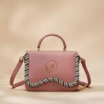 pink faux-leather crossbody bag with a top handle and a twisted rope-style trim.