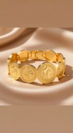 gold-plated coin bracelet is a piece