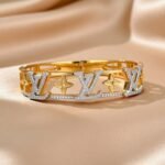 Vuitton style titanium steel openable bangle bracelet with a gold-plated finish