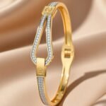 gold-plated bangle bracelet decorated with cubic zirconia stones.