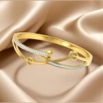 gold-plated, white cubic zirconia studded bangle-style bracelet