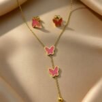 jewelry set is a stylish accessory featuring a golden butterfly design with pink enamel.