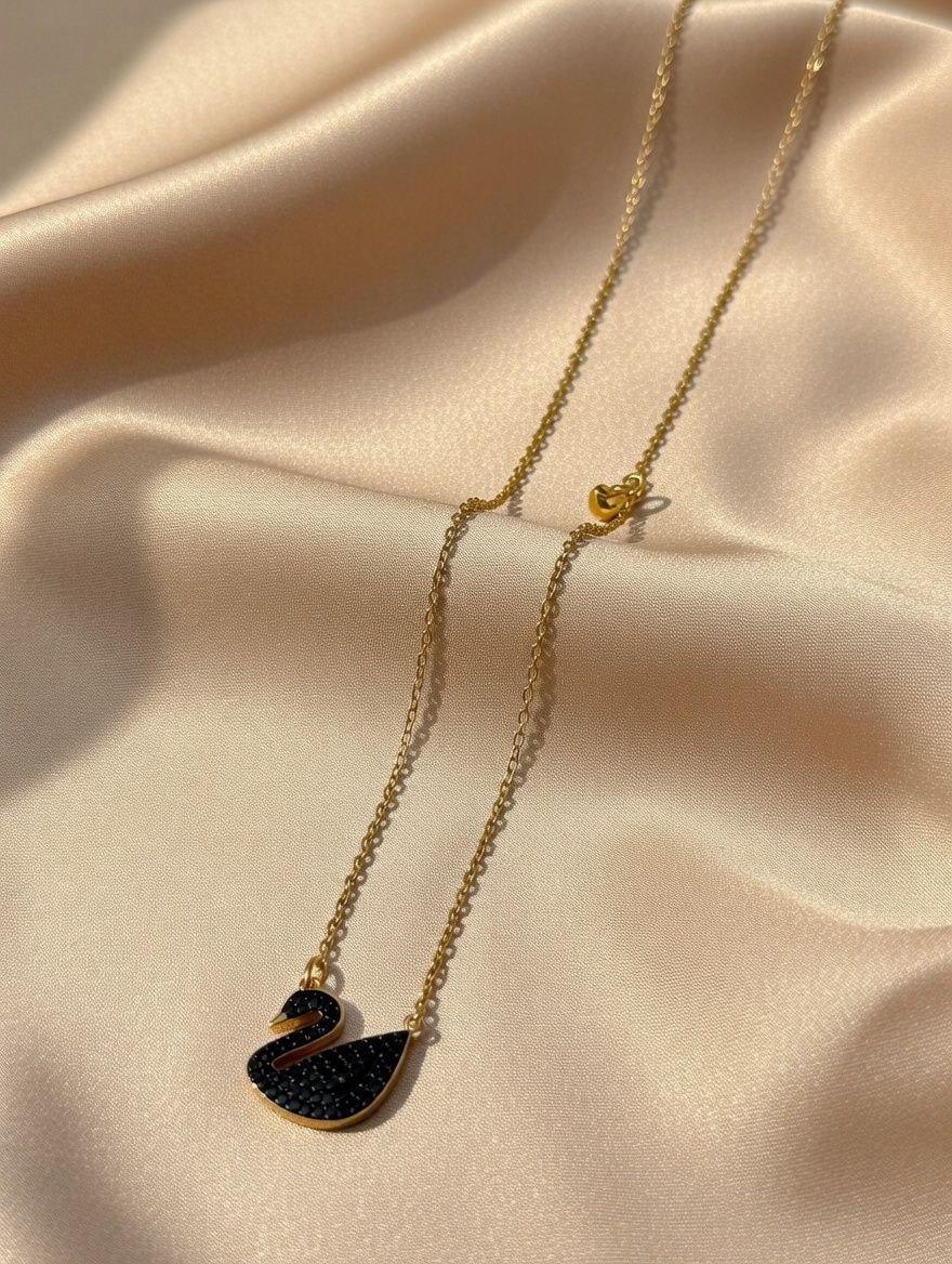 photo_10_2026-02-24_03-04-36.jpg lack swan pendant on a gold-toned chain, - Image 1