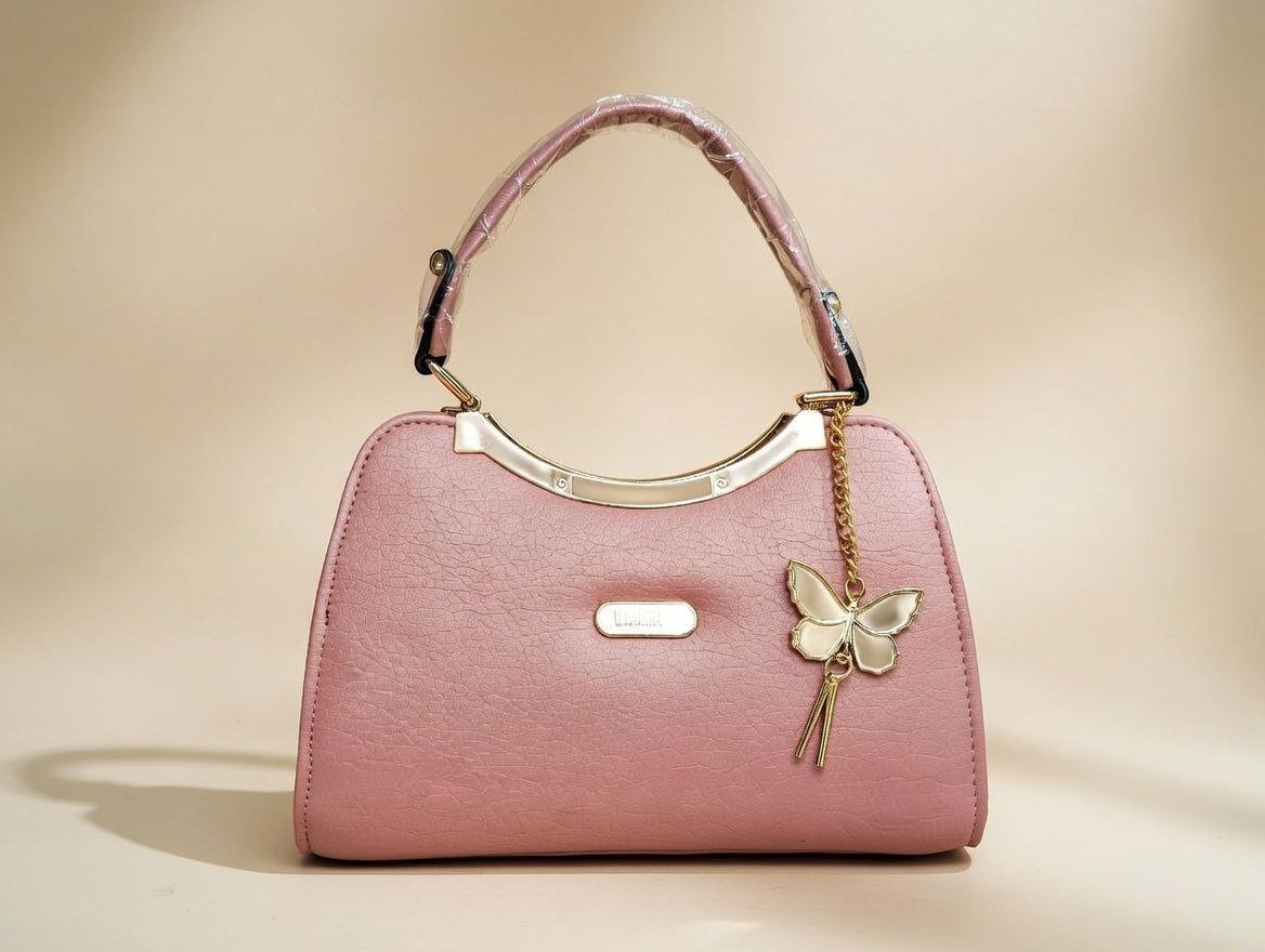 photo_12_2026-02-10_01-00-55.jpg pink PU leather handbag with a butterfly charm. - Image 1