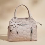 women's fashion handbag made of PU leather with a flower accessory.