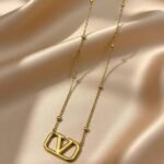 Valentino Garavani VLogo Signature pendant necklace in a gold-tone finish.