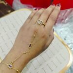 gold ring bracelet featuring rectangular stones.