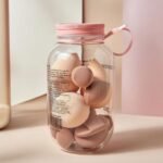 makeup blender sponges and powder puffs in a storage jar.
