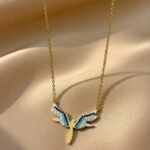 dainty angel wing necklace featuring gold-plated silver and zircon stones.