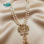 necklace features a trendy double-strand pearl chain