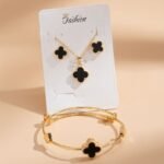 gold-plated, stainless steel four-leaf clover design with black enamel centers,